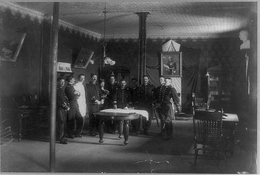 Mexican military officers standing around a table in a planning room