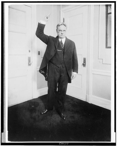 Hiram W. Johnson, standing, full-length, with right arm raised