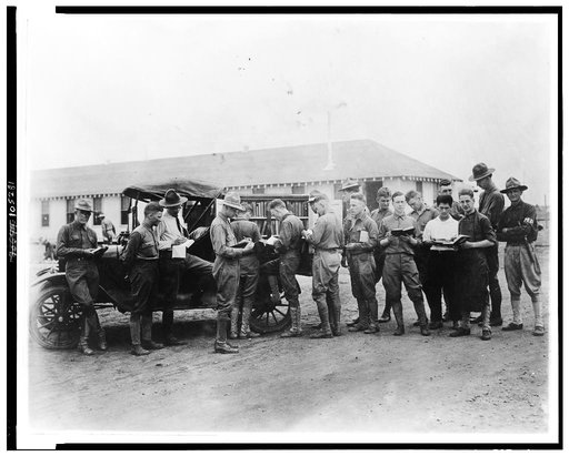 U.S. soldiers getting library books from truck, Kelly Field Library