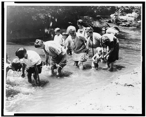 Women and children find some relief by wading in the creek on one of the hottest days in the history of the Capital. Snapped in Rock Creek Park today