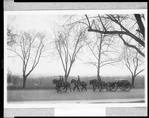 Military funerals at Arlington National Cemetery--men on six horses pulling casket on wagon