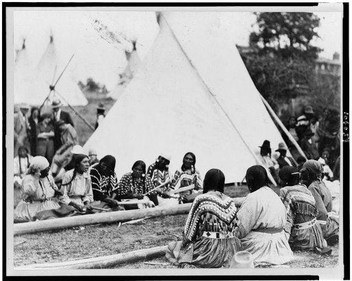 Indian women playing the stick game at the midsummer celebration on the Glacier National Park Reservation, Montana