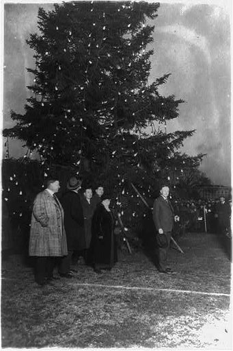 President Coolidge illuminating the community Christmas tree, which has been erected on the Monument Grounds, south of the White House