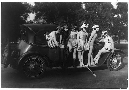 Seven Mack Sennett bathing beauties standing around a car