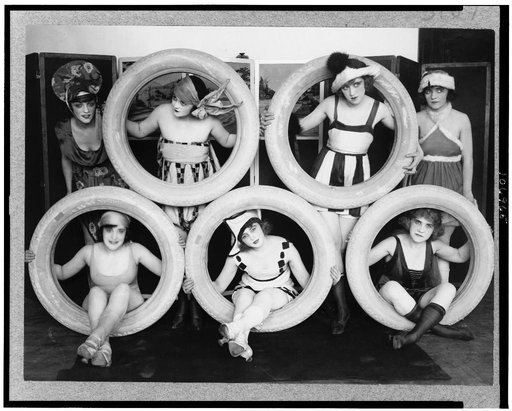 Mack Sennett girls in costumes posed with tires