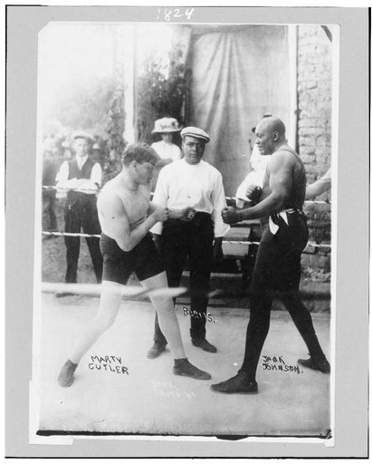 Boxers Marty Cutler and Jack Johnson in ring, with Burns, referee(?)