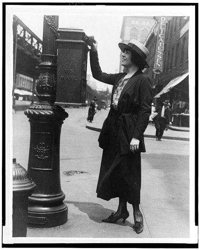 Merle Alcock mailing a letter in New York City