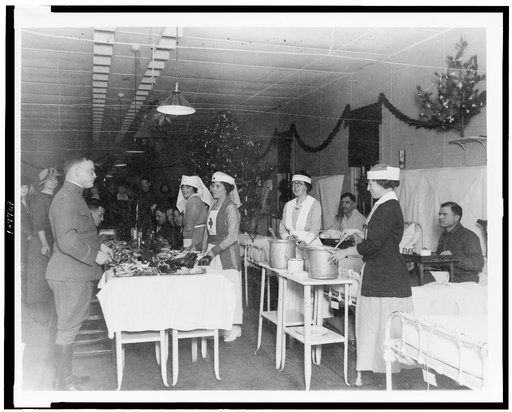 Red Cross nurses serving food to soldiers in hospital, during Christmas season