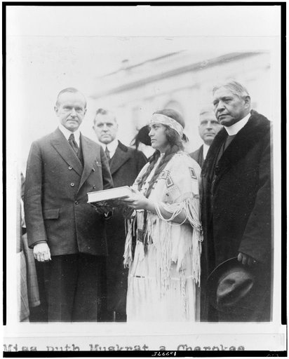 Miss Ruth Muskrat, a Cherokee Indian, presents Mr. Coolidge with a copy of The Red Man in the United States, a survey of the present day American Indian