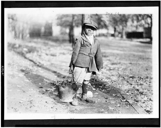 Young boy carrying a bucket of coal, Washington, D.C. or New York City