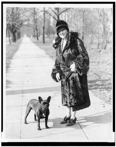 Mary Roberts Rinehart, well known writer, snapped while out for a stroll with her favorite pet