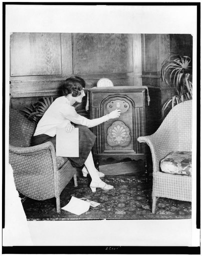 Young woman tuning a radio