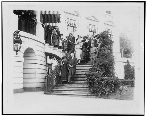 Pres. Warren G. Harding escorting Madame Curie down steps to south grounds of the White House