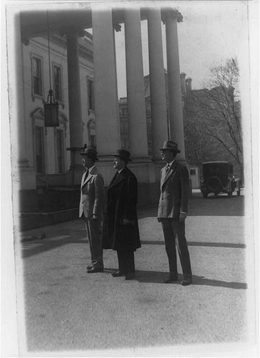 President Coolidge inspecting work being done at the White House. Col E. Sterling, Pres. Coolidge and Col. Cheney, military aide to the president