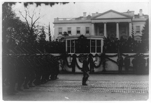 U.S. presidential inauguration. Calvin Coolidge on platform in front of White House reviewing military parade