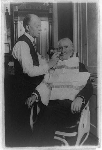 Uncle Joe Cannon getting one of his last congressional shaves. Bert Broden has been Uncle Joe's barber for the past twelve years