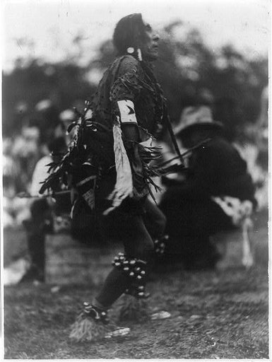 Chief Turtle giving his interpretation of the Indians' storm dance, just before the rain came down in torrents, at the Indian celebration in Two Medicine Valley, Glacier National Park, Montana