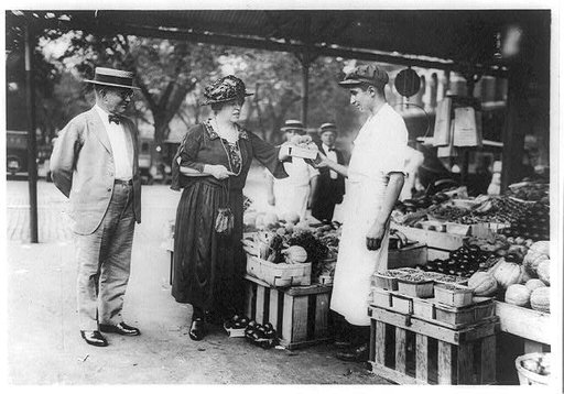 Man and woman buying produce at an outdoor market, Washington, D.C.(?)