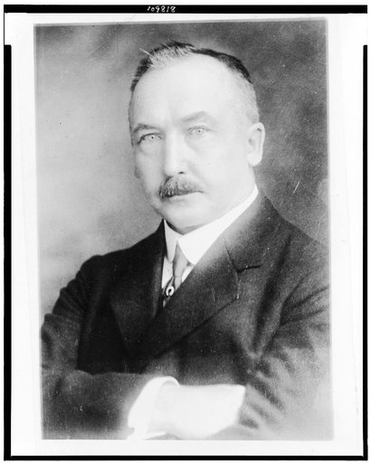 Clifford Sifton, half-length portrait, facing slightly left, arms folded