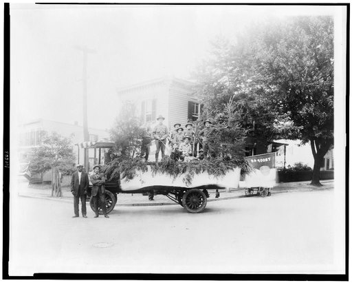 Boy Scouts posed with a truck decorated for a parade, probably in the Anacostia section of Washington, D.C.