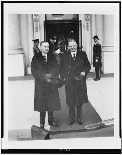 Calvin Coolidge and Herbert Hoover, full-length portraits, standing, wearing overcoats and holding top hats