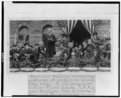 President Coolidge addressing graduates of Georgetown University today--In the background Justice Pierce Butler, U.S. Supreme Court, Rev. John B. Creeden, President of Georgetown University, Gov. Wm. S. Flynn of R.I.