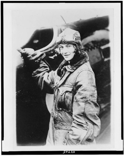 Miss Mary Fechet, daughter of James E. Fechet, Chief of the Air Corps, half-length portrait, standing by airplane, facing left