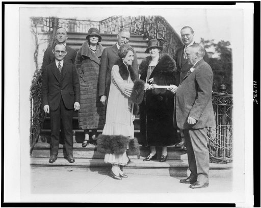 Mrs. Coolidge receives a fur coat from the Fur Dealers Assn.