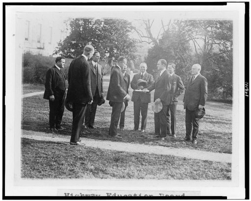 President Coolidge standing with members of the Highway Education Board on the White House lawn