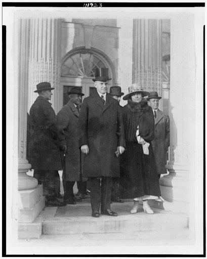 President and Mrs. Coolidge leaving D.A.R. Hall after attending meeting of the Budget Committee