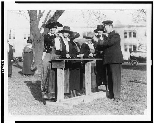 Women police officers inspecting and practicing with handguns