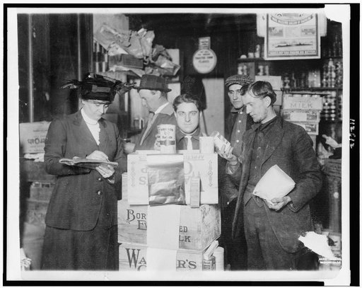 Woman in the Red Cross Commission's warehouses at Rotterdam, Holland giving American canned food to refugees