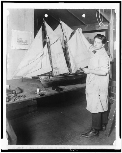 Paul E. Garber of the Construction Department of the National Museum with ship model