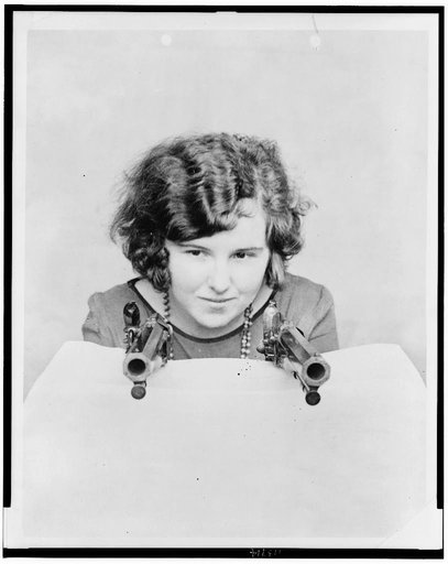 Miss Grace Stockman with President Andrew Jackson's dueling pistols, at the National Museum