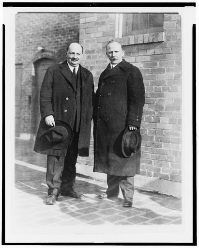 Lyudvig Martens (left) and his secretary, Mr. S. Nuorteva(right), posed standing, full-length, facing front