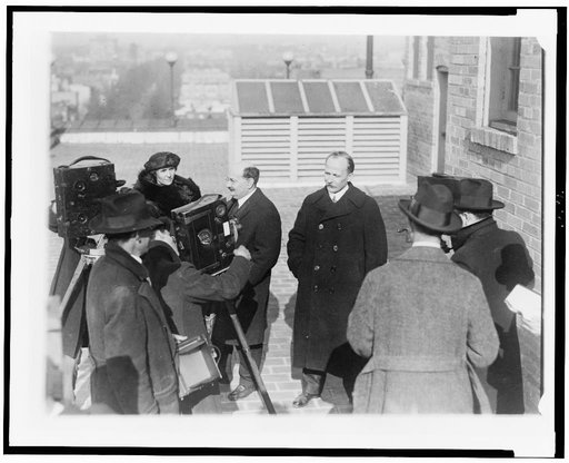 Ludwig Martens (right), representative of the Soviet government, with his secretary, Mr. S. Nuorteva (left), and Madam Nuorteva, posed on roof, for motion picture camera crew