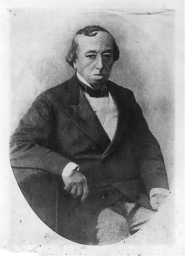 Benjamin Disraeli, three-quarter length, seated, facing right