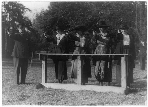 Training a policewoman--target practice under the direction of Inspector Cross of the police department--Inspector Cross demonstrates the correct way to hold a "gat"