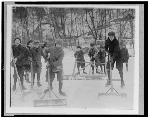 Boys cleaning snow off the ice, so that they can ice skate, Washington, D.C., area