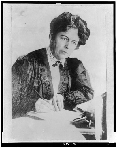 Harriot Stanton Blatch, half-length portrait, seated, facing slightly right, writing