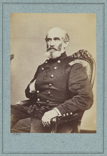 A.J. Smith, three-quarter length portrait, seated, facing right, right hand in his coat