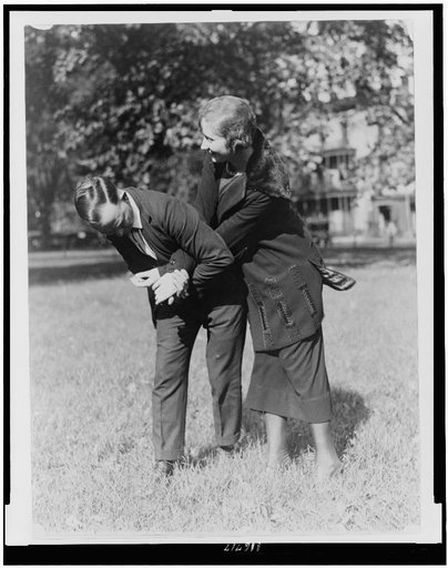 Policewoman and policeman practicing self-defense