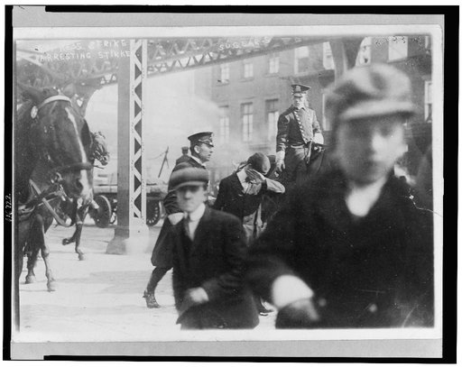 Two policemen arresting a striker in Express strike, New York City