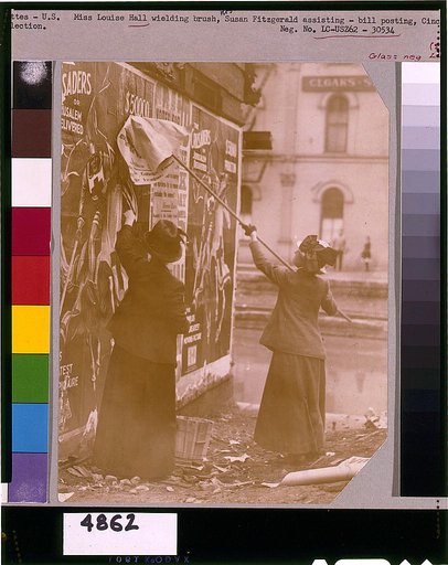 Louise Hall, with brush, and Susan Fitzgerald pasting billboard posters, Cincinnati, May 1912