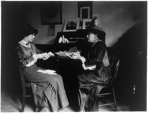 Mrs. Helen Gardener and Miss Alice Paul, seated, full-length portrait, at desk