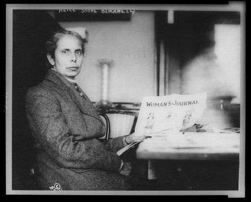 Alice Stone Blackwell, half-length portrait, seated, facing right, holding copy of Woman's Journal, of which she was editor