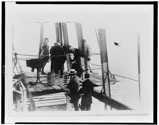 Insurance co. pres. John Rogers Hegeman driving last rivet, Metropolitan Life building tower