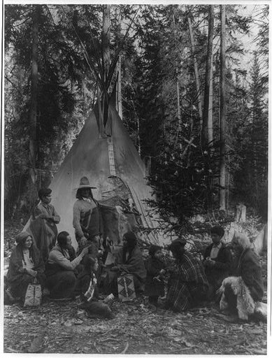 Flathead Indians holding pre-Christmas family gatherings on the west side of Glacier National Park, in the dense forest of evergreen trees that skirt the Rocky Mountains