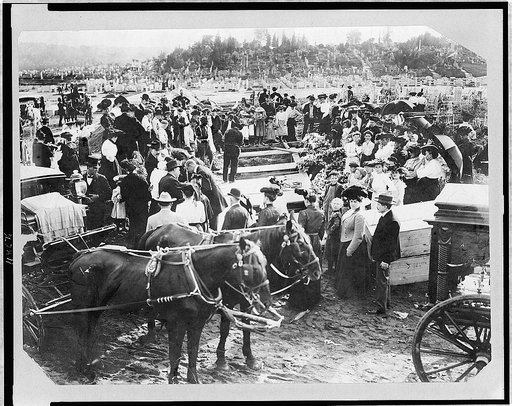 Crowd and horse-drawn hearses at mass burial in cemetery, North Collingwood, Ohio
