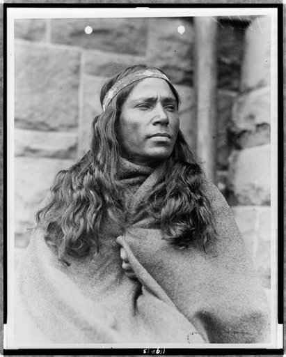 Baby Lone, Kickapoo medicine man, half-length portrait, facing right, wrapped in blanket